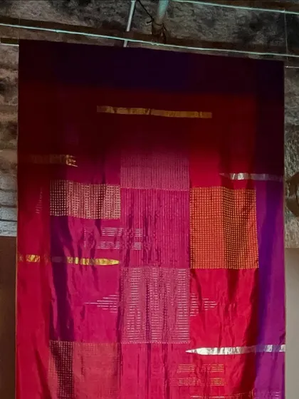 A stunning display of a patchwork silk saree from the 'Pampa - Textiles of Karnataka' exhibition. This piece celebrates the rich colors and textures of the state's weaving traditions.