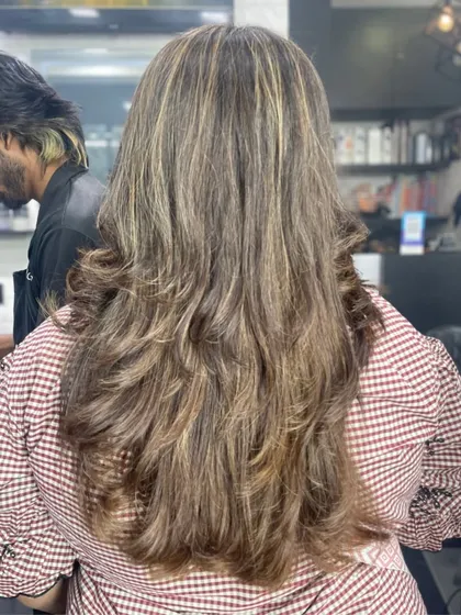 Thick, healthy hair styled in layers with highlights to add texture and movement.