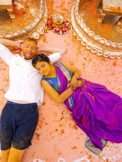 A wedding is a collection of beautiful moments. This quiet pause after a vibrant Haldi ceremony, with the couple resting amidst a canvas of turmeric and mandala art, captures the beautiful blend of playful energy and deep connection that we love to create.