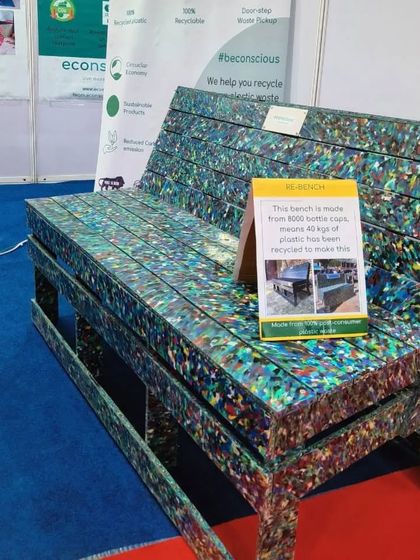 A close-up of our standard park bench on display. The vibrant, confetti-like texture comes from thousands of different pieces of plastic, making every single bench one-of-a-kind.