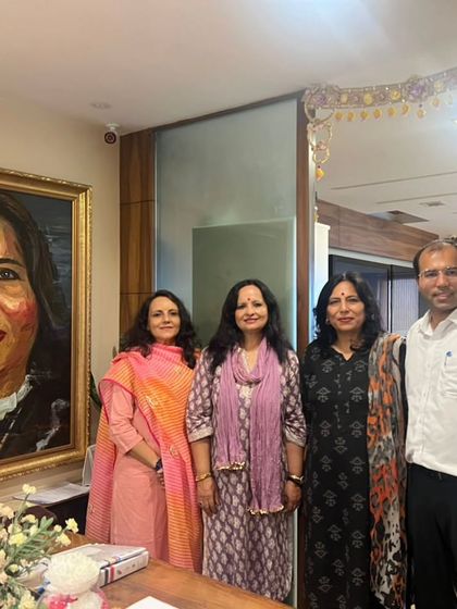 A happy moment with family and friends in my office, standing before a portrait that means a lot to me. I am filled with gratitude for their support.