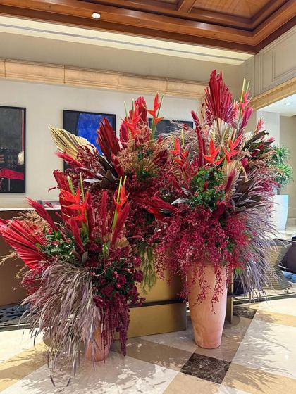 A collection of smaller arrangements complementing the main Christmas installation. This approach creates a cohesive and immersive experience throughout the lobby space.