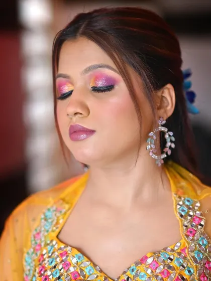A close-up of the colorful eye makeup for the Haldi look. The blend of pink, purple, and yellow creates a stunning, festive effect.