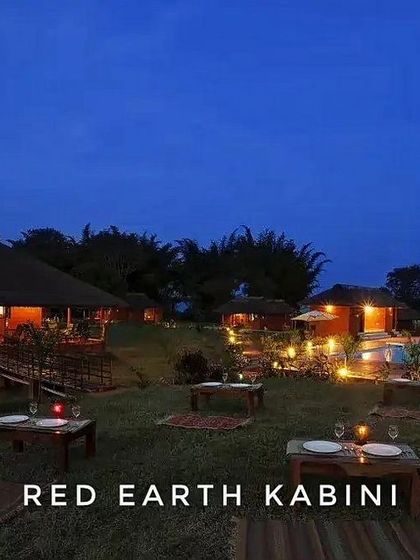 The magical evening ambiance at Red Earth, Kabini, with outdoor dining setups perfect for a romantic dinner under the stars.