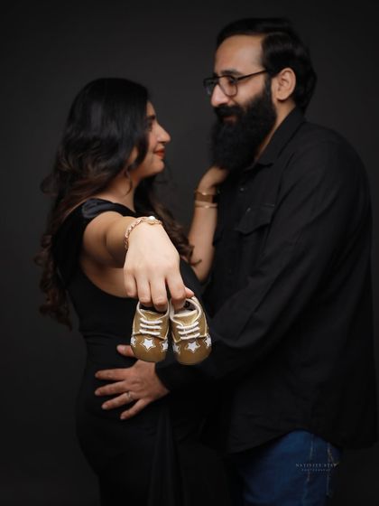 A sweet close-up of a couple holding tiny baby shoes. This classic prop is a beautiful way to symbolize the new life you're waiting for.