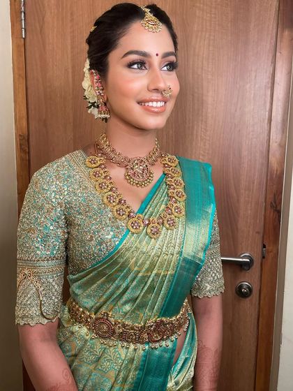 A timeless South Indian bride. Her smile says it all. The makeup is radiant and fresh, letting her happiness be the focus.