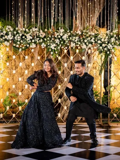 The dance floor is the heart of any Sangeet. We designed this elegant stage with a floral backdrop and a classic checkered floor, setting the scene for a night of celebration.