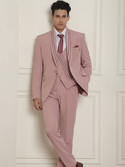 Another stunning pastel pink suit, this one with unique lapel detailing. Our in-house tailoring gives us the edge to provide endless options.