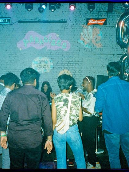 A behind-the-scenes film shot of the DJ booth before the night kicked off. The calm before the storm, with our custom chain-link balloon decor ready to go.