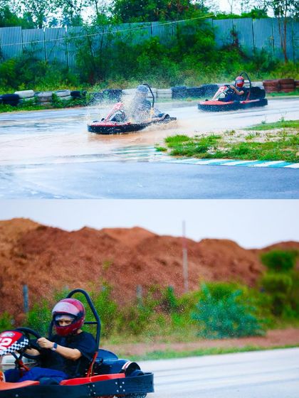Two karts battling it out in the rain. One driver kicks up a spray of water while the other carefully navigates the slick surface behind.