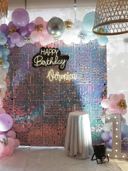 The full view of the glamorous 10th birthday setup, including the light-up marquee numbers and a pedestal for the birthday cake.