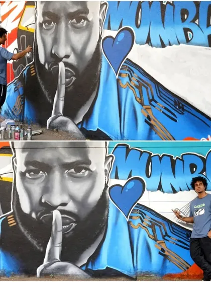 An artist from Mooz Graffiti stands with his completed mural of cricketer Kieron Pollard. This two-panel shot shows the process and the final, impressive result of the portrait.