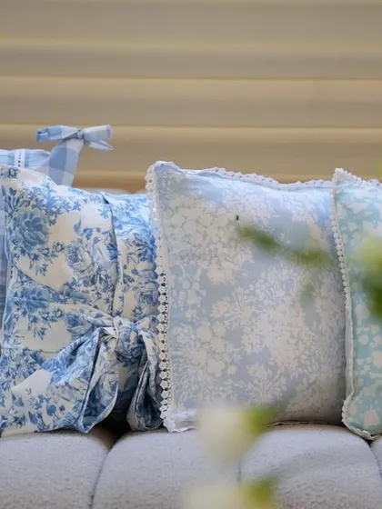 A close-up of the custom-printed pillows in various blue and white patterns.