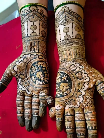 This design features a large, circular floral pattern in the center of the palm, a style known as a mandala. The dark fill makes the delicate flowers inside stand out beautifully.