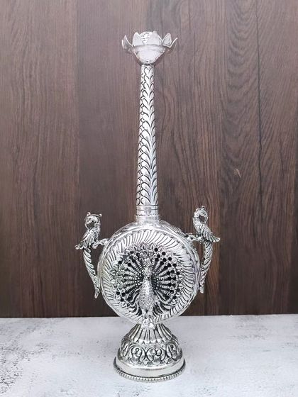 An antique German silver paneer daani with a peacock motif. This is a highly decorative piece that is also functional.