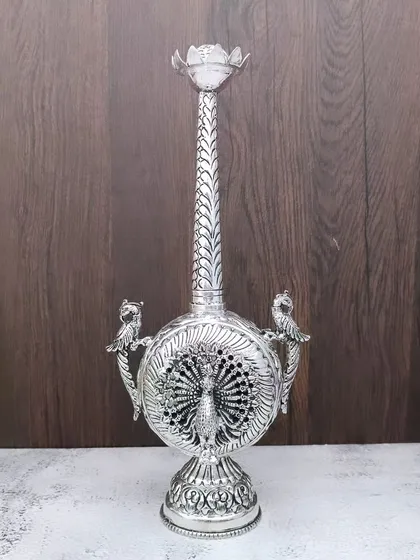 An antique German silver paneer daani (rose water sprinkler) with a large peacock carved on its body, a truly unique and beautiful piece.