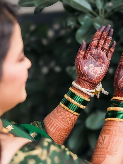 The bride showing off her personalized mehendi, which often tells a story of the couple.
