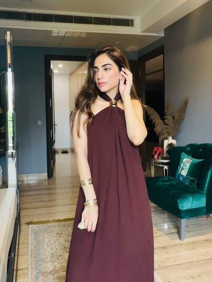 Another look at the maroon Rakhi outfit, showing how the halter neckline and gold accessories create a balanced and modern ethnic style.