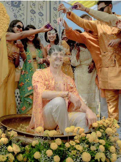 The vibrant energy of a Haldi ceremony in full swing. I capture the laughter, the splashes, and the uninhibited joy as friends and family shower the groom in love and turmeric.