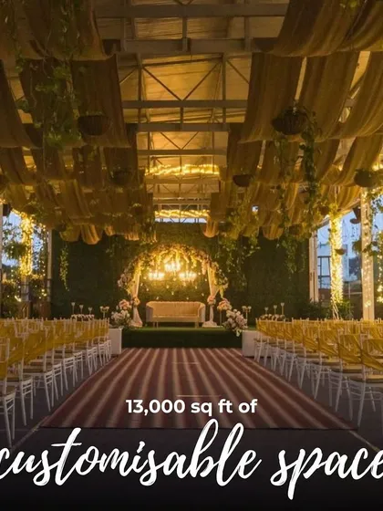 A full view of the Sky Terrace set up for a wedding ceremony, showing the long aisle, guest seating, and the grand stage under a draped ceiling.