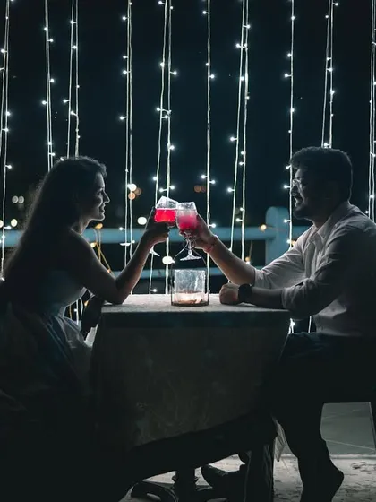 A romantic date night setup is a perfect theme for a pre-wedding shoot. Here, we used fairy lights and a cozy table setting to create an intimate, silhouetted portrait that feels straight out of a movie.