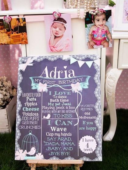 A personalized chalkboard sign for a first birthday. These signs are a wonderful keepsake, capturing all the favorite things and milestones of the birthday girl.