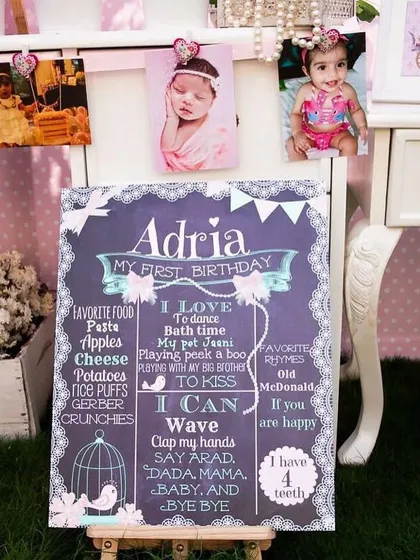 A personalized chalkboard sign for a first birthday. These signs are a wonderful keepsake, capturing all the favorite things and milestones of the birthday girl.