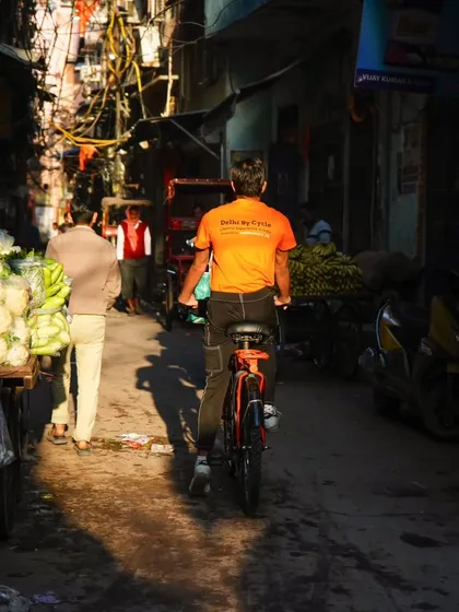 One of our guides navigates a narrow lane filled with fresh produce. Our tours give you a front-row seat to the daily life and commerce of the old city.