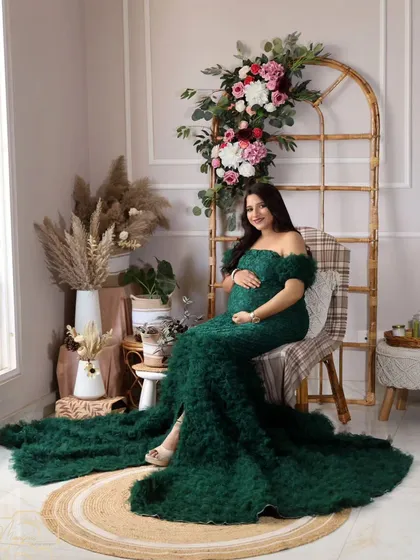 A full-length shot of the stunning dark green gown in the boho corner. The color is rich and unique, perfect for a memorable portrait.