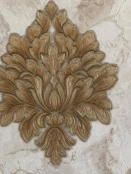 A detailed look at a classic damask wallpaper. The raised, fabric-like texture of the motif on a subtly patterned background adds a sense of luxury and tradition.