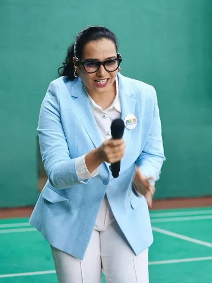 Bringing the hype to a corporate sports league. Dressed in a professional yet approachable blazer, I love engaging with participants and building excitement. It shows how I can adapt my energetic style to a corporate setting, making it fun yet focused.