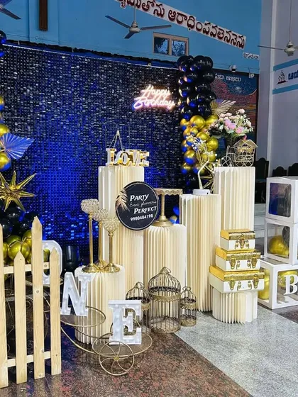 Another view of the grand blue shimmer wall decoration. This angle shows the arrangement of the picket fence, pedestals, and decorative birdcages that complete the look.