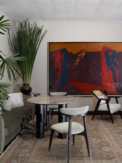 Another view of the India Art Fair VIP Lounge, where a large, colourful painting provides a dramatic backdrop for a dining or meeting area. The space was designed to reflect the depth and evolving language of contemporary Indian design.