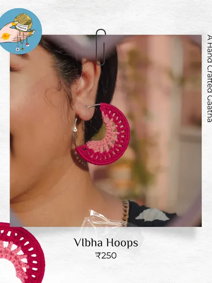 A close-up of the 'Vibha' hoops in a beautiful magenta. The two-tone design adds a little extra detail, all while being super lightweight thanks to the cotton yarn.