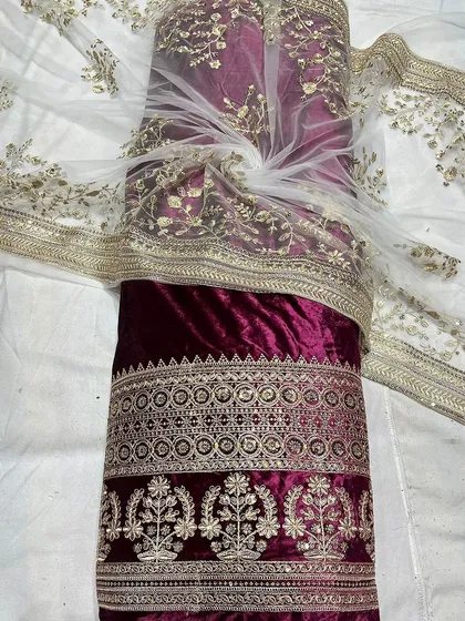 I've paired this rich maroon viscose velvet with a delicate embroidered net fabric. This combination is perfect for creating opulent lehengas or salwar suits that feel both royal and handcrafted.