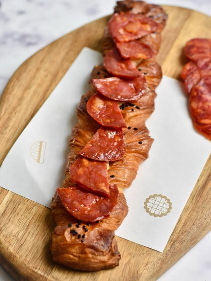 A Spanish Chorizo Twisty, a savory pastry from our limited-edition pop-up menu. The spicy chorizo is twisted into our buttery, flaky dough.