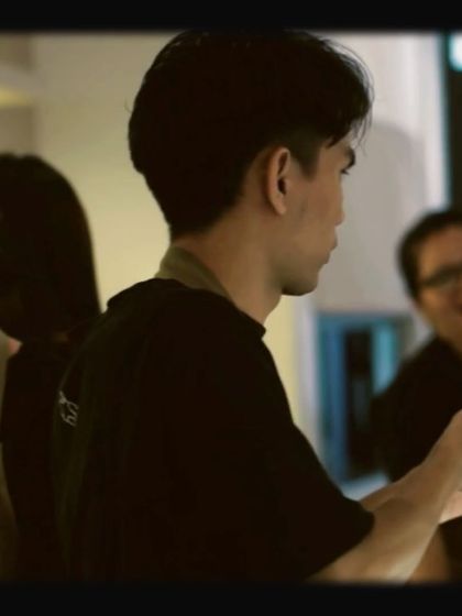 A candid shot of our baristas working together behind the counter, with a laugh in the background.
