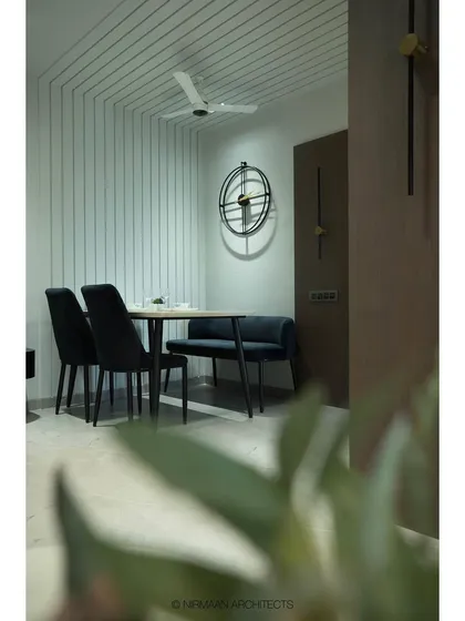 A cozy dining nook at our Tulsi Heights project. We used linear patterns on the wall and a comfortable bench seating to create an intimate and stylish space that feels distinct yet connected to the living area.