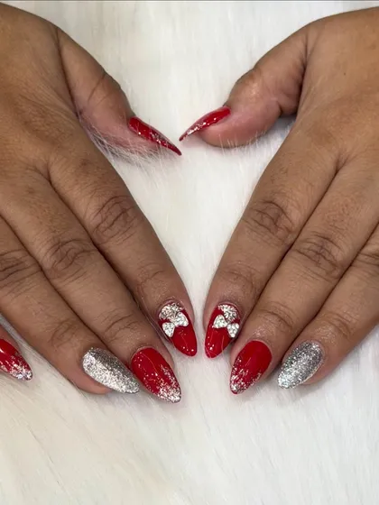 A fun and festive set perfect for the holidays. Bright red nails are paired with silver glitter and cute 3D silver bows for a playful touch.