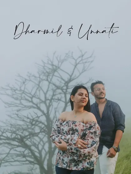 A moody and romantic portrait of a couple in the foggy hills of Igatpuri. The bare tree adds a touch of artistic drama to the scene.