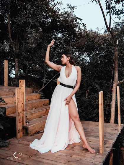 A graceful and artistic pose on a wooden platform in the woods. This shot feels like a scene from a beautiful, enchanting story.