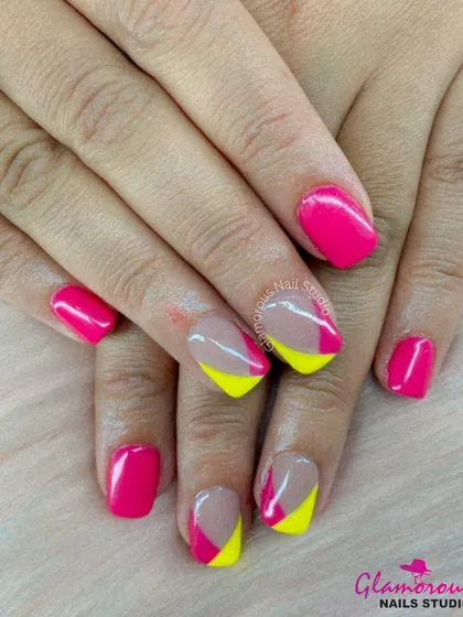 A fun and modern color-block design, this look combines solid hot pink nails with accent nails featuring a geometric pattern of pink and yellow.