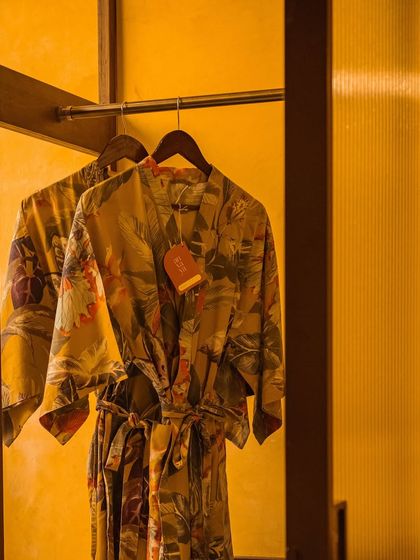 Our custom robes hanging in an open closet, ready for you to slip into comfort and serenity.