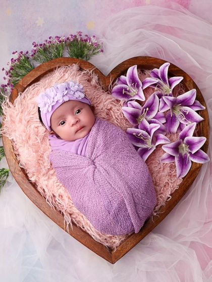 A full view of the heart-shaped bowl setup, with the baby looking so tiny and perfect.
