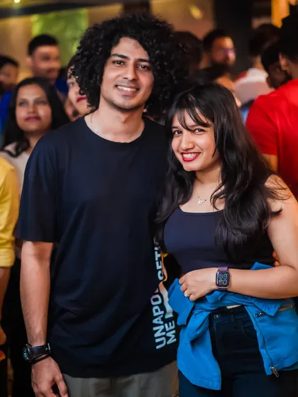 A happy couple enjoying the crowded and energetic atmosphere.