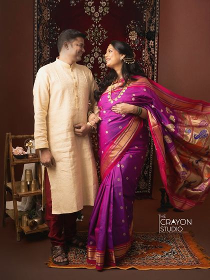 Dressed in a stunning purple Paithani saree, this couple shares a look of love. The rich, traditional backdrop in my studio adds a touch of classic elegance to their maternity portraits.