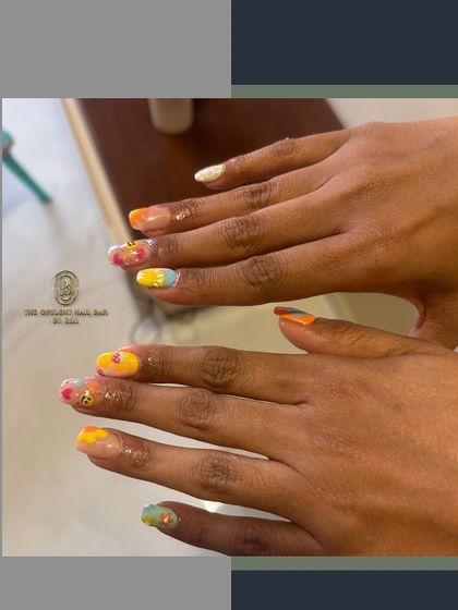 A fun and playful summer manicure. This set features a mix of bright colors, smiley faces, and floral patterns for a look that's full of personality.