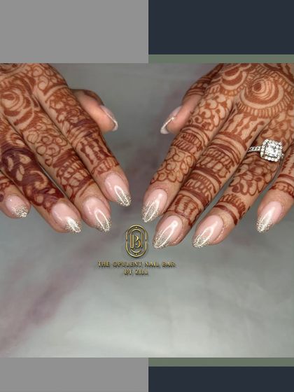 The perfect bridal nails. A soft glitter ombré on a sheer nude base beautifully complements the intricate henna design.