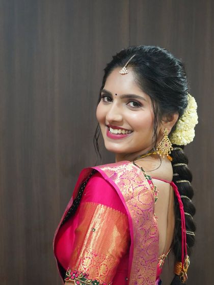 A view of the traditional braid and fresh flowers in Vindya's hair, a classic choice for pre-wedding functions.