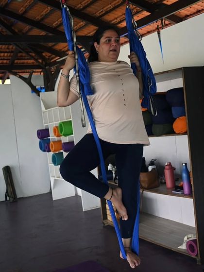 A student confidently holding a pose in the aerial hammock. It's so rewarding to see participants build strength and trust in themselves throughout the session.